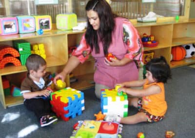Educator playing with 2 to 3 year old children