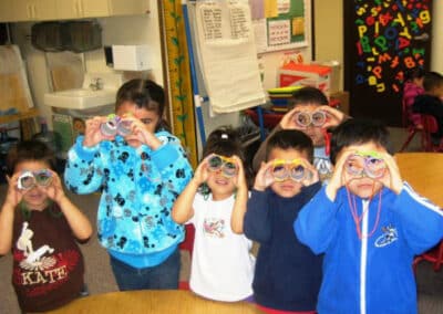 Children showing toy binoculars they created and decorated.