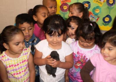 Children holding an animal in the classroom