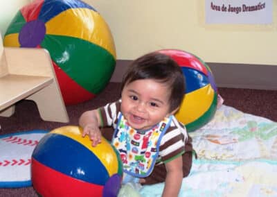 Baby playing with beach balls.