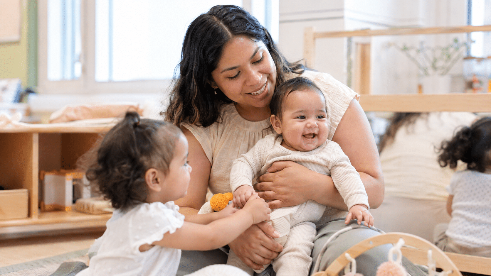 Child care provider caring for an infant and toddler