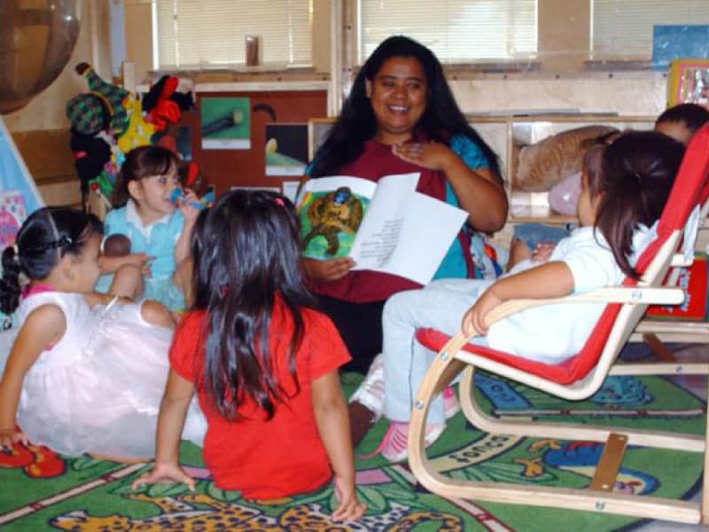 CCCDS educator reading books to children during story time